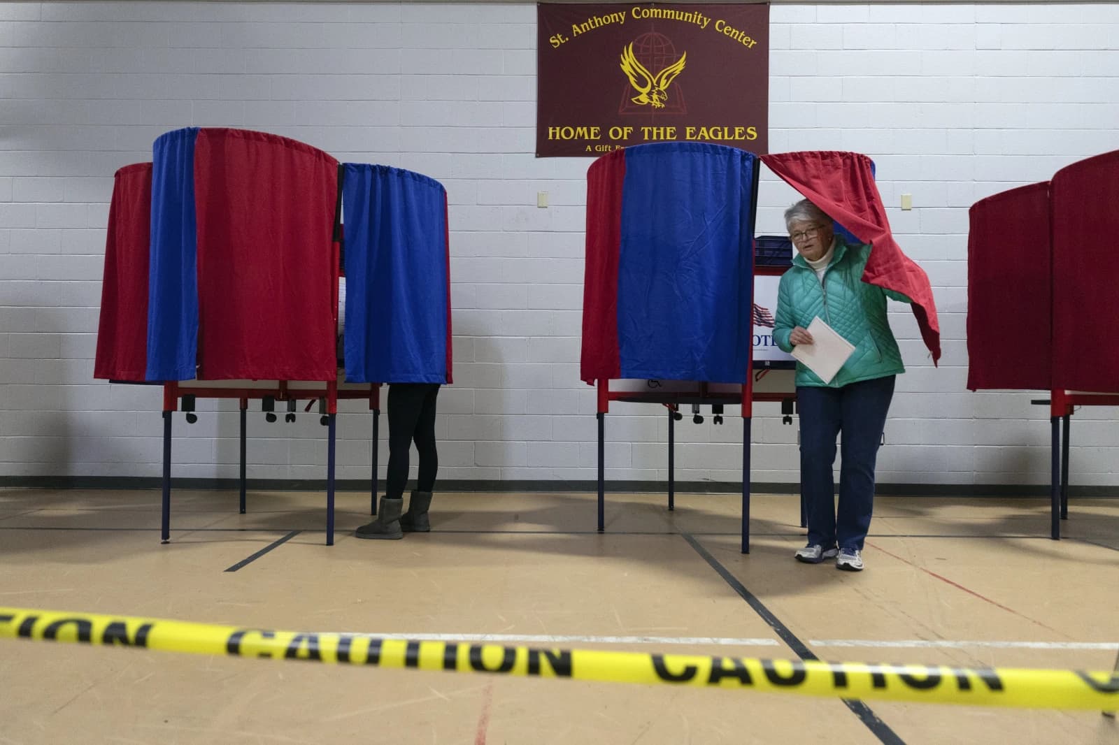 A voter at the New Hampshire primary leaves the voting booth