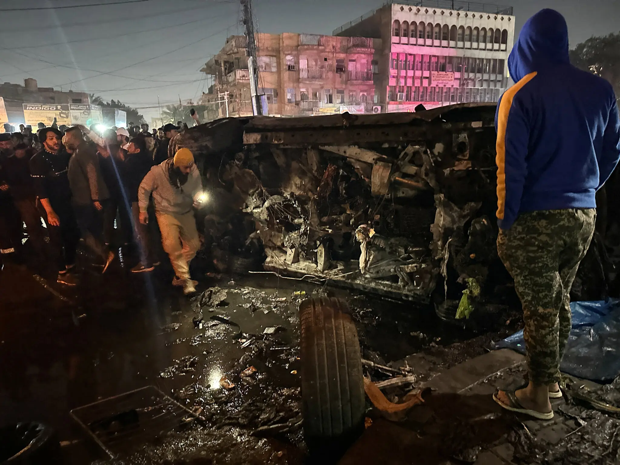 Inspection of a destroyed vehicle in Baghdad