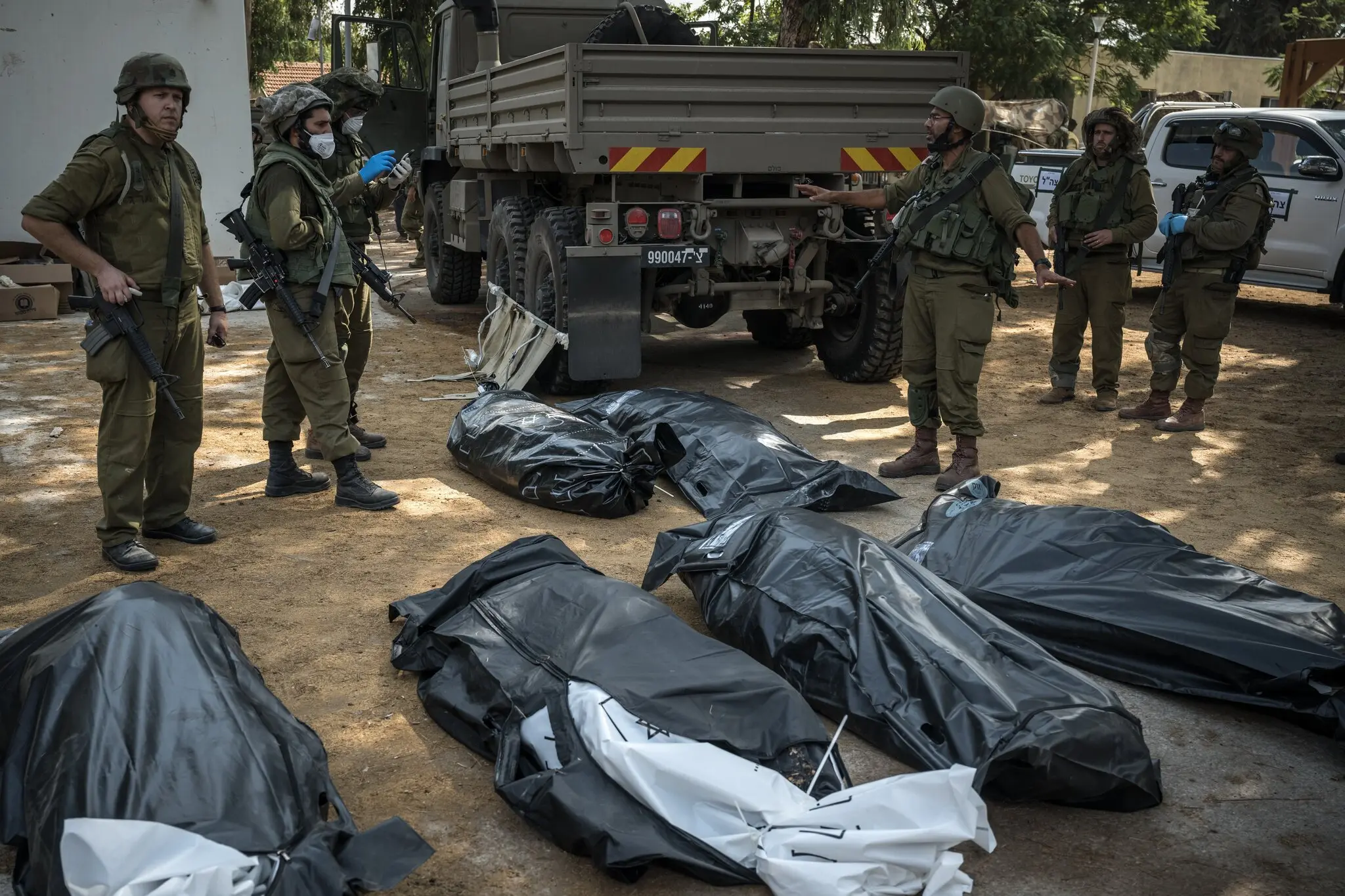Israeli soldiers with victims of October 7th