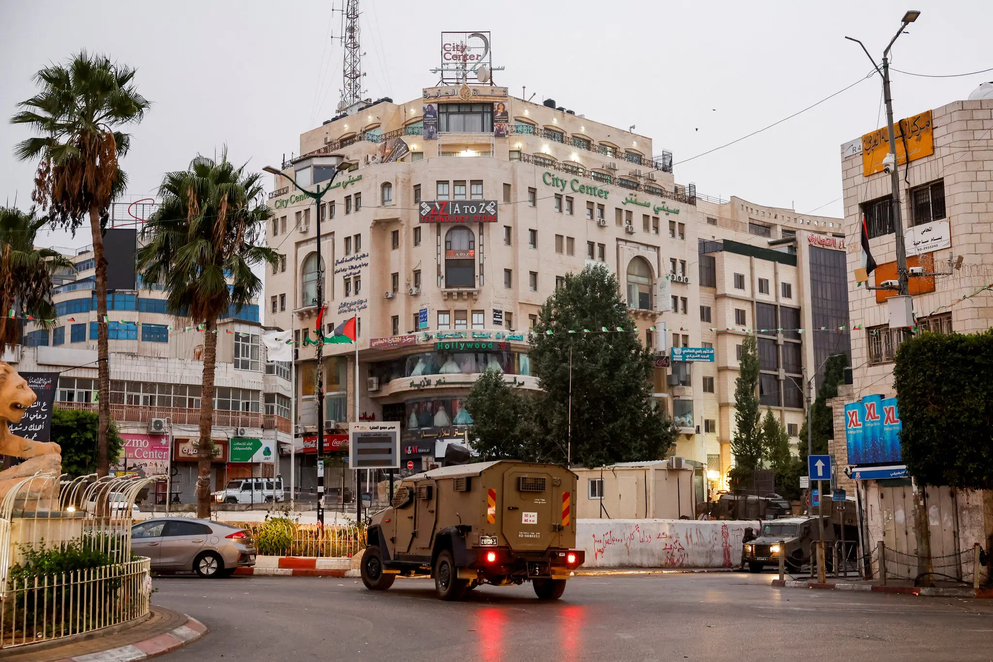 An Israeli military truck in front of a building in the West Bank