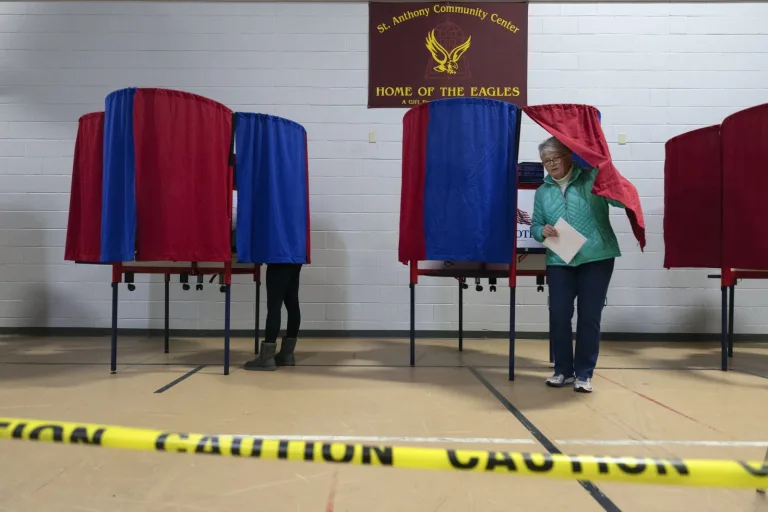 A voter at the New Hampshire primary leaves the voting booth
