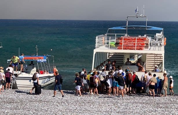 People evacuating via boat